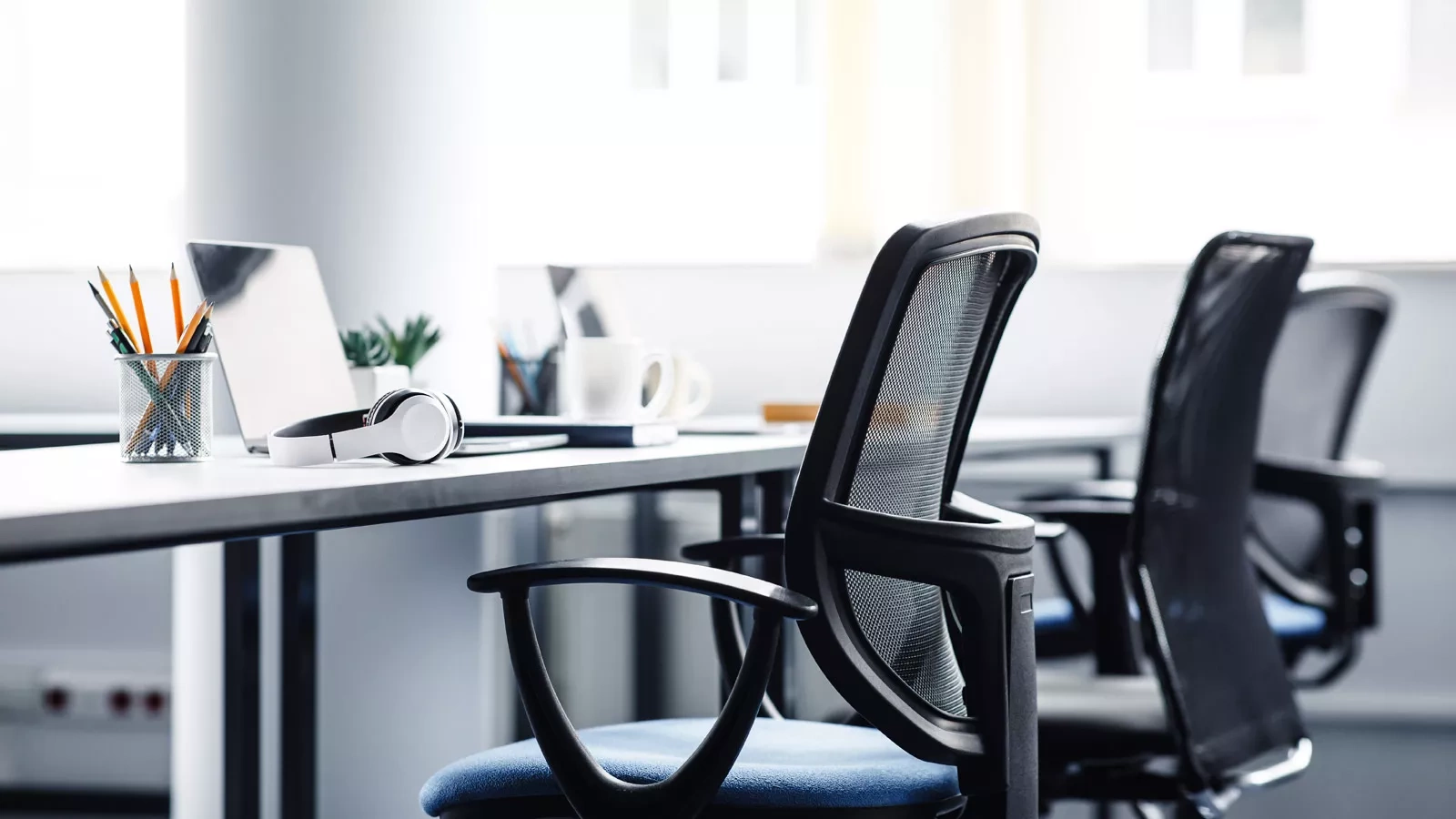 Two desk chairs in front of a desk